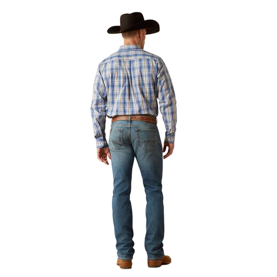 Man wearing a plaid shirt, jeans, and a cowboy hat on a plain background