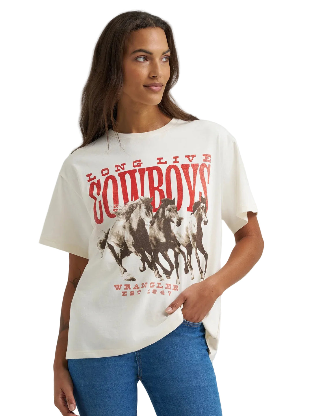 Woman wearing a Wrangler 'Long Live Cowboys' t-shirt with graphic design on a plain background